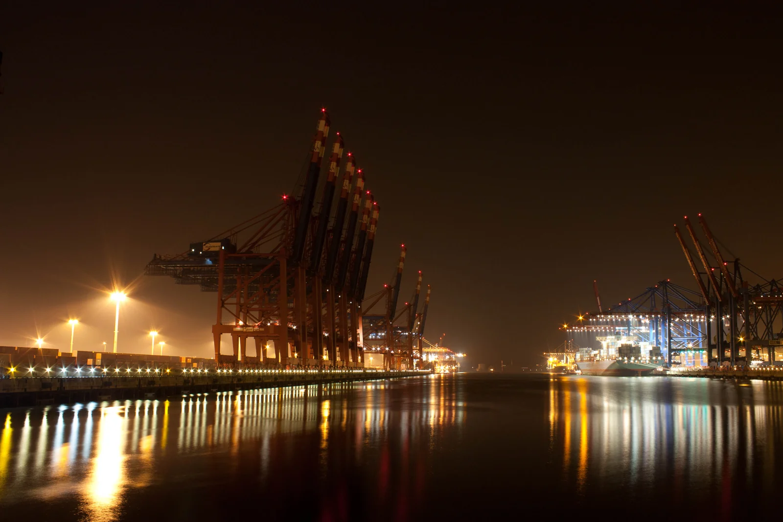 Illuminated gantry cranes handling cargo at a container terminal